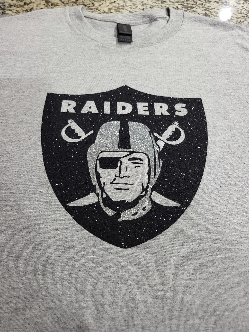 Raiders Glitter Logo T-Shirt – Silver & Black Sparkle Fan Tee (silver helmet)