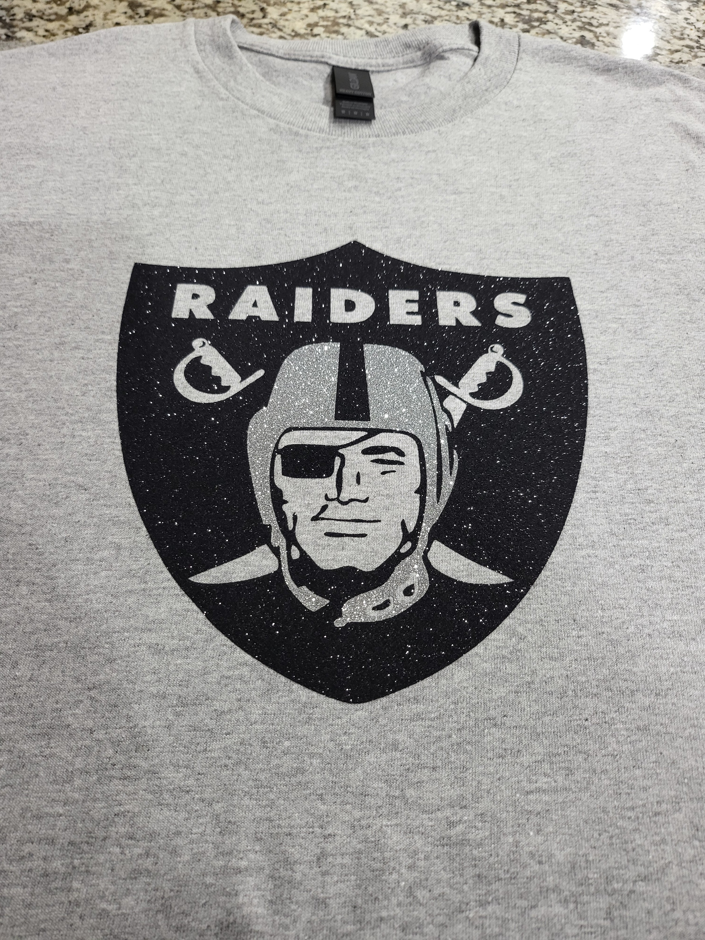 Raiders Glitter Logo T-Shirt – Silver & Black Sparkle Fan Tee (silver helmet)